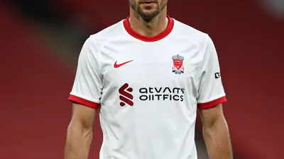 Liverpool F.C. unveils its 2026/27 Adidas away kit, a white strip with red and grey details, featuring CLIMACOOL+ tech...
